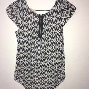 Black and white blouse with gold zipper.